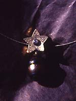 star pendant with dark pearl drop and diamond